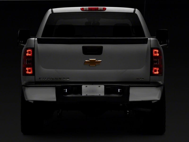 Raxiom 01-13 Chevrolet Silverado/GMC Sierra 1500 Axial Series LED License Plate Lamps- Smoked Raxiom 01-13 Chevrolet Silverado/GMC Sierra 1500 Axial Series LED License Plate Lamps- Smoked