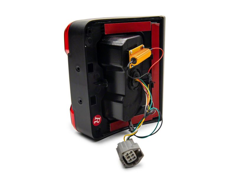 Raxiom 07-18 Jeep Wrangler JK Axial Series JL Style LED Tail Lights- BlkHousing- Red Lens Raxiom 07-18 Jeep Wrangler JK Axial Series JL Style LED Tail Lights- BlkHousing- Red Lens