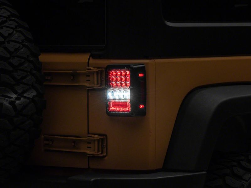 Raxiom 07-18 Jeep Wrangler JK Axial Series Lux LED Tail Lights- Blk Housing (Clear Lens) Raxiom 07-18 Jeep Wrangler JK Axial Series Lux LED Tail Lights- Blk Housing (Clear Lens)