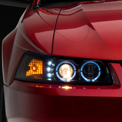 Raxiom 99-04 Ford Mustang Dual LED Halo Projector Headlights- Black Housing (Clear Lens)