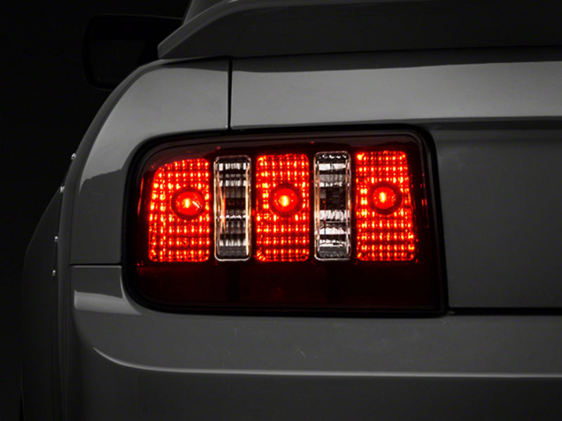Raxiom 05-09 Ford Mustang Coyote Tail Lights- Blk Housing (Smoked Lens) Raxiom 05-09 Ford Mustang Coyote Tail Lights- Blk Housing (Smoked Lens)