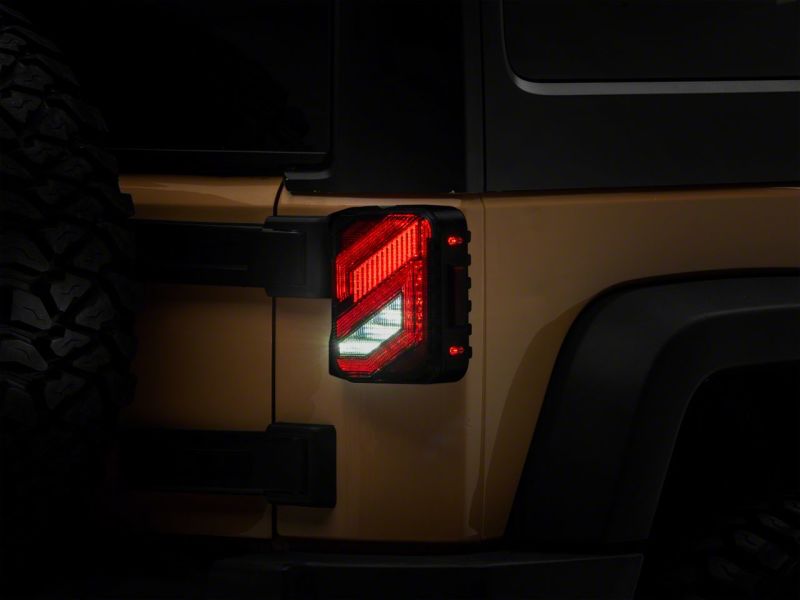 Raxiom 07-18 Jeep Wrangler JK Axial Series Trident LED Tail Lights- Blk Housing (Clear Lens) Raxiom 07-18 Jeep Wrangler JK Axial Series Trident LED Tail Lights- Blk Housing (Clear Lens)