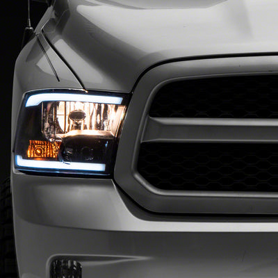 Raxiom 09-18 Dodge RAM 1500/2500/3500 Axial Series Headlights w/ LED Bar- Blk Housing (Clear Lens)