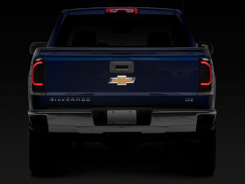 Raxiom 14-18 Chevrolet Silverado 1500 Axial Series LED Tail Lights- Blk Housing (Smoked Lens) Raxiom 14-18 Chevrolet Silverado 1500 Axial Series LED Tail Lights- Blk Housing (Smoked Lens)