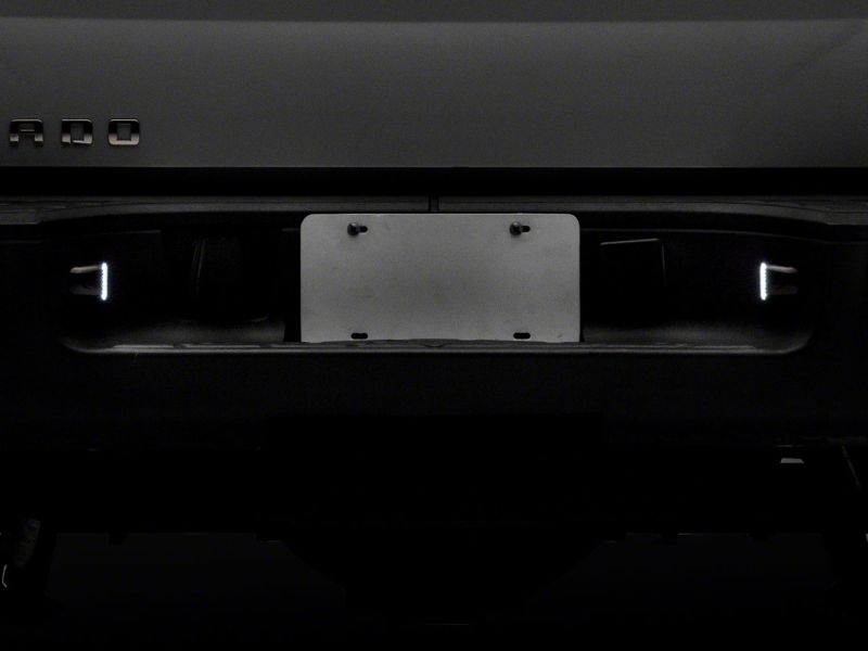 Raxiom 01-13 Chevrolet Silverado/GMC Sierra 1500 Axial Series LED License Plate Lamps- Smoked Raxiom 01-13 Chevrolet Silverado/GMC Sierra 1500 Axial Series LED License Plate Lamps- Smoked