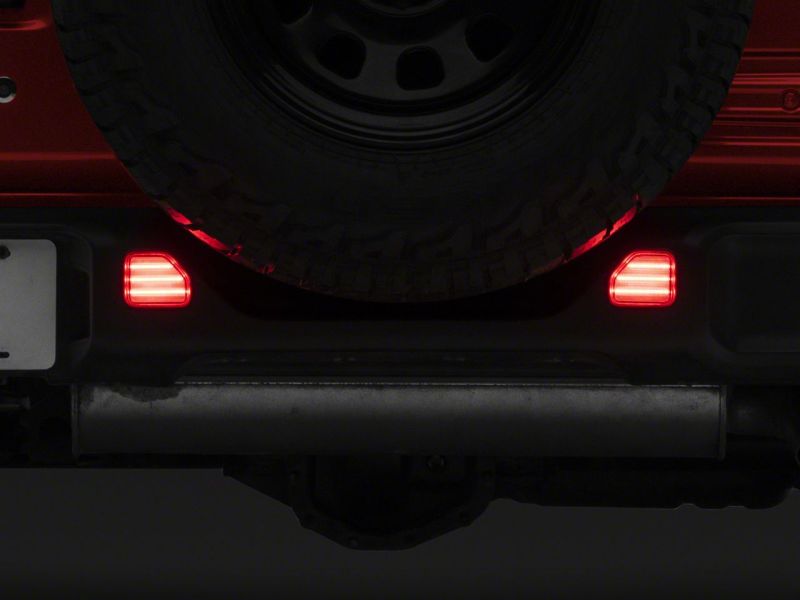 Raxiom 18-23 Jeep Wrangler JL Moab Rubicon Sahara Axial LED Rear Bumper Reflector Lights- Clear Raxiom 18-23 Jeep Wrangler JL Moab Rubicon Sahara Axial LED Rear Bumper Reflector Lights- Clear