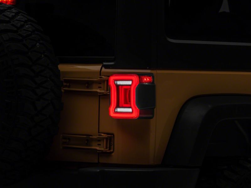 Raxiom 07-18 Jeep Wrangler JK Axial Series JL Style LED Tail Lights- BlkHousing- Red Lens Raxiom 07-18 Jeep Wrangler JK Axial Series JL Style LED Tail Lights- BlkHousing- Red Lens