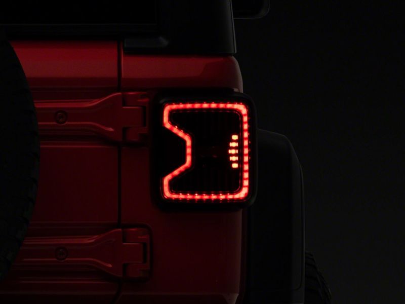 Raxiom 18-23 Jeep Wrangler JL LED Tail Lights- Blk Housing (Smoked Lens) Raxiom 18-23 Jeep Wrangler JL LED Tail Lights- Blk Housing (Smoked Lens)