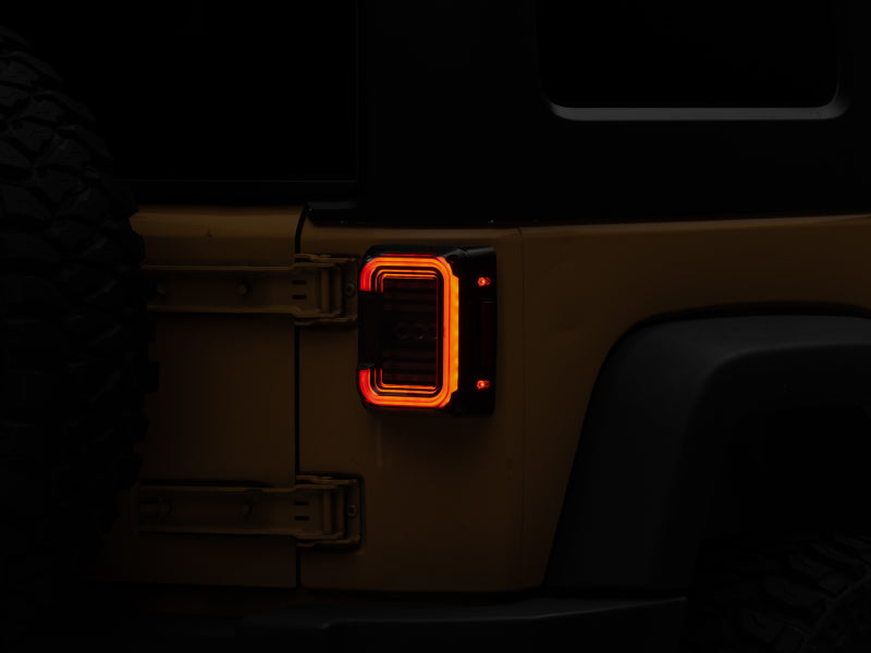 Raxiom 07-18 Jeep Wrangler JK Axial Series LED Halo Tail Lights- Black Housing (Dark Smoked Lens) Raxiom 07-18 Jeep Wrangler JK Axial Series LED Halo Tail Lights- Black Housing (Dark Smoked Lens)