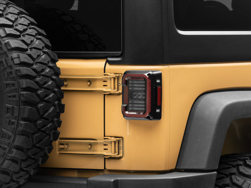 Raxiom 07-18 Jeep Wrangler JK Axial Series LED Halo Tail Lights- Black Housing (Dark Smoked Lens) Raxiom 07-18 Jeep Wrangler JK Axial Series LED Halo Tail Lights- Black Housing (Dark Smoked Lens)