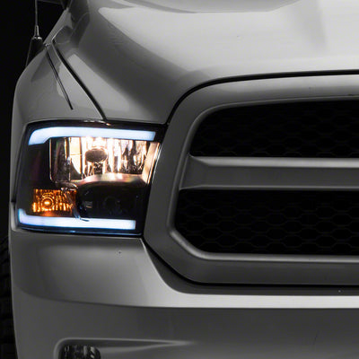Raxiom 09-18 Dodge RAM 1500/2500/3500 Axial Headlights w/ SEQL LED Bar- Blk Housing (Clear Lens)