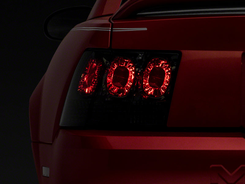 Raxiom 99-04 Ford Mustang Axial Series Altezza Style Tail Lights- Blk Housing (Smoked Lens) Raxiom 99-04 Ford Mustang Axial Series Altezza Style Tail Lights- Blk Housing (Smoked Lens)