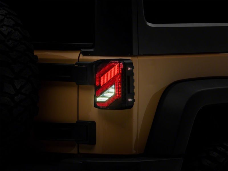 Raxiom 07-18 Jeep Wrangler JK Axial Series Trident LED Tail Lights- Blk Housing (Smoked Lens) Raxiom 07-18 Jeep Wrangler JK Axial Series Trident LED Tail Lights- Blk Housing (Smoked Lens)