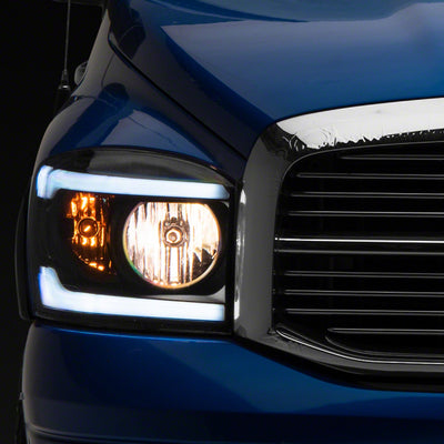 Raxiom 06-09 Dodge RAM 1500/2500/3500 Axial Headlights w/ SEQL LED Bar- Blk Housing (Clear Lens)