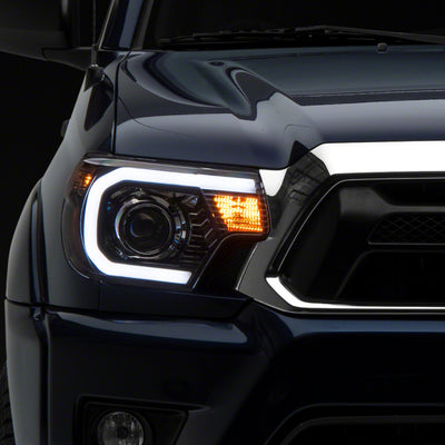 Raxiom 12-15 Toyota Tacoma Axial Projector Headlights w/ SEQL LED Bar- Blk Housing (Clear Lens)