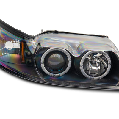 Raxiom 99-04 Ford Mustang Dual LED Halo Projector Headlights- Black Housing (Clear Lens)