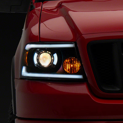 Raxiom 04-08 Ford F-150 Axial Series Projector Headlights w/ SEQL LED Bar- Blk Housing (Clear Lens)
